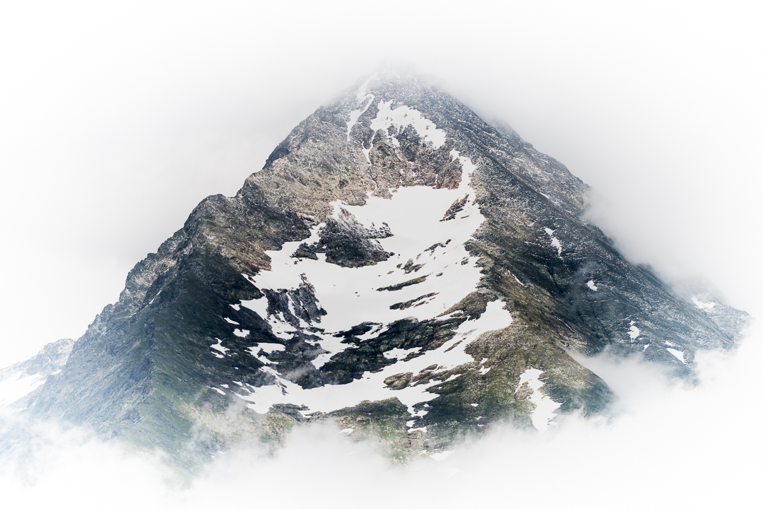 A mountain peak surrounded by clouds